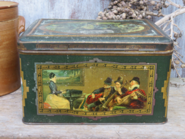 Antieke groene blikken trommel met musicerende figuren