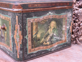 Antieke groene blikken trommel met musicerende figuren