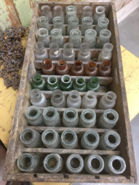 Antique wooden crate with (colored) bottles