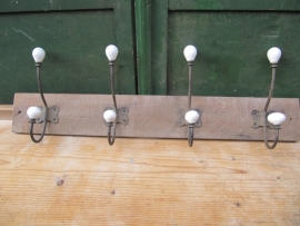 Coat rack with 4 porcelain spheres.