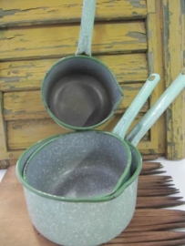 Set of old enamel pans in spotted green