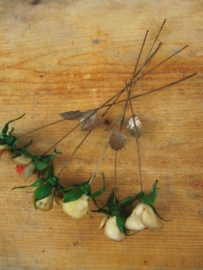 Old plastic flowers on metal, six