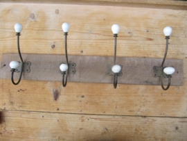 Coat rack with 4 porcelain spheres.