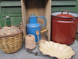 Brocante bottle in a basket with label and sealing wax on the cap