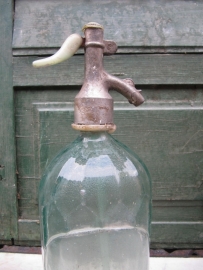 Seltzer soda bottle with light green faceted and label holder