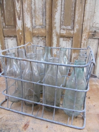 Old brocante crate with 12 milk bottles of 1 liter.