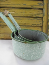 Set of old enamel pans in spotted green