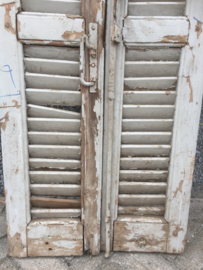 Antique double louvered doors set with espagnolette closure.