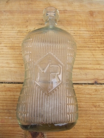 Very old liquor bottle in special fun shape.