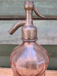 Seltzer soda bottle in salmon pink with inscription