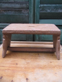 Old wooden stool with handle.