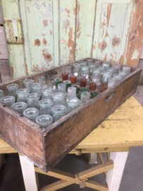 Antique wooden crate with (colored) bottles
