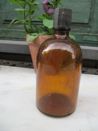 Round old brown medicine bottle with cap.
