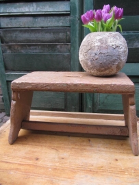Old wooden stool with handle.