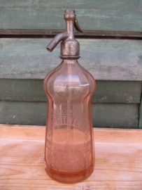 Seltzer soda bottle in salmon pink with inscription