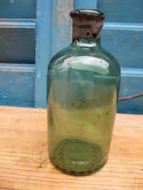 Old small round green bottle.