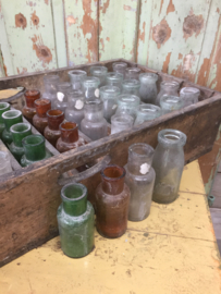 Antique wooden crate with (colored) bottles