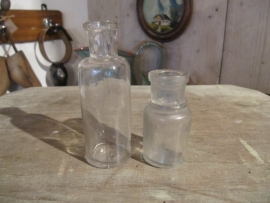 Brocante cylindrical clear glass bottle.