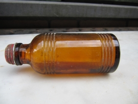 French old brown bottle with red cap Perma Paris