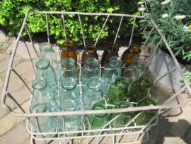 Old metal crate filled with 20 half-liter bottles in fun colors.