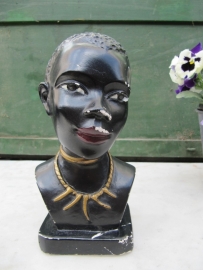 Old bust statue of dark woman