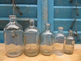 Set of 5 very old white round glass bottles