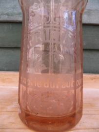 Seltzer soda bottle in salmon pink with inscription