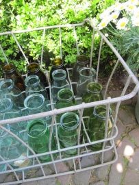 Old metal crate filled with 20 half-liter bottles in fun colors.