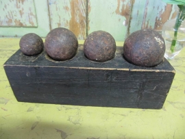 Antique bal shape weights on wooden stand