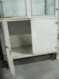 Pharmacists metal cabinet with glass shelves