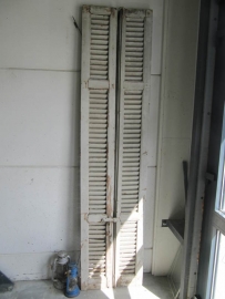 Antique double louvered doors set with espagnolette closure.