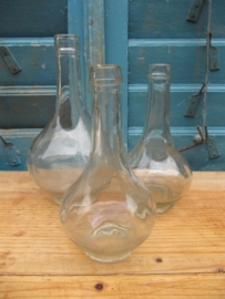Set of three blank white spherical glass bottles