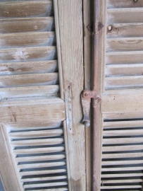 Antique louvered door into 3 sections with espanjolet closure