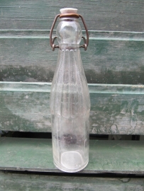 White old bottle of 0.25 liter with porcelain cap.