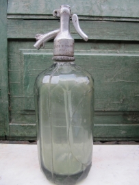 Seltzer soda bottle with light green faceted and label holder
