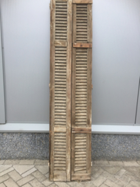 Antique double louvered doors set with espagnolette closure.