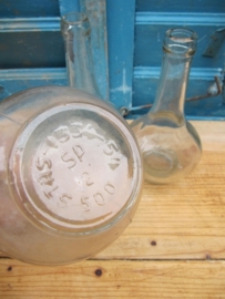 Set of three blank white spherical glass bottles