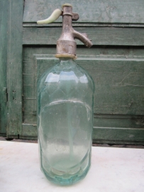 Seltzer soda bottle with light green faceted and label holder