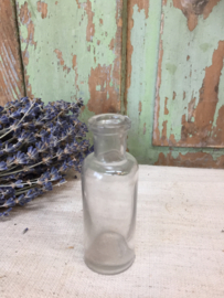 Brocante cylindrical clear glass bottle.