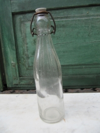 White old bottle of 0.25 liter with porcelain cap.
