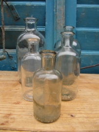 Set of 5 very old white round glass bottles