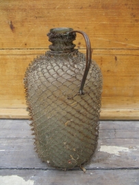 Old bottle with wire mesh and metal handle