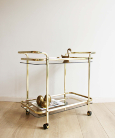 Gouden vintage trolley / bijzettafel met rookglazen bladen. Vintage sidetable