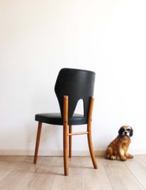 Zwarte vintage stoel. Retro Mid Century design eetkamerstoel