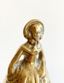 Vintage tafelbelletje in de vorm van een dame. Goudkleurige (tutte) bel