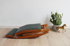 Vintage voetenbankje met groene skai bekleding. Houten retro schommelbankje