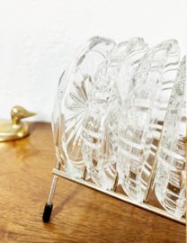 Set vintage onderzettertjes van glas in houder. 11 glazen onderzetters