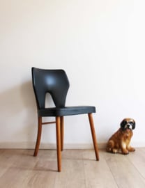 Zwarte vintage stoel. Retro Mid Century design eetkamerstoel