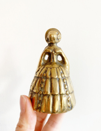 Vintage tafelbelletje in de vorm van een dame. Goudkleurige (tutte) bel