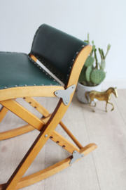 Vintage voetenbankje met groene skai bekleding. Houten retro schommelbankje